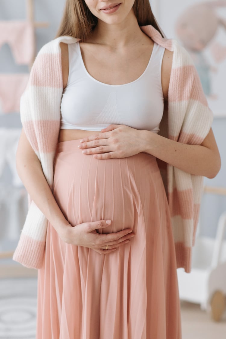 A Pregnant Woman Rubbing Her Baby Bump